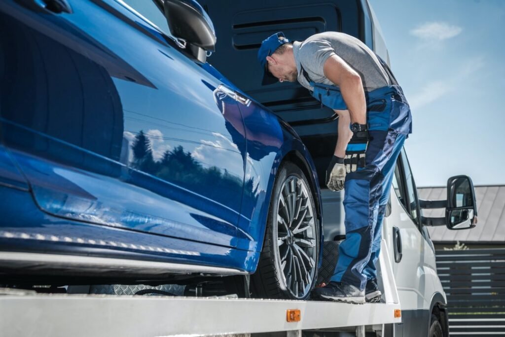 A man providing auto recovery service beside a car and truck on the roadside in Crestwood,IL.