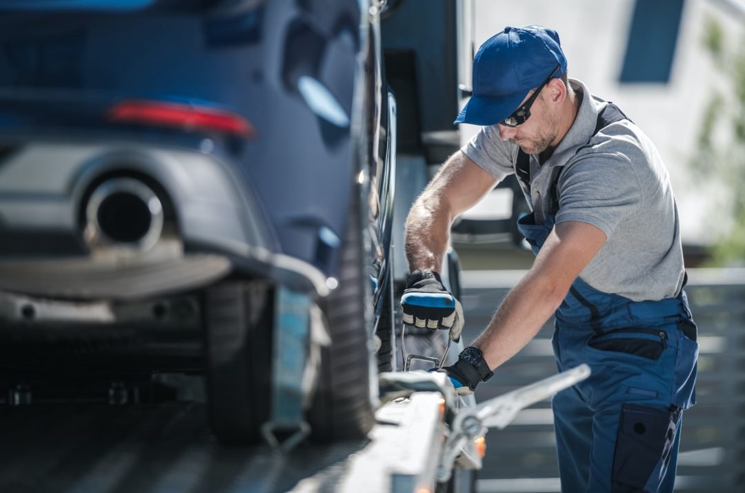 A man decking a car onto a towing truck for tow truck service in Burbank,IL. A man decking a car onto a towing truck for tow truck service in Burbank,IL.