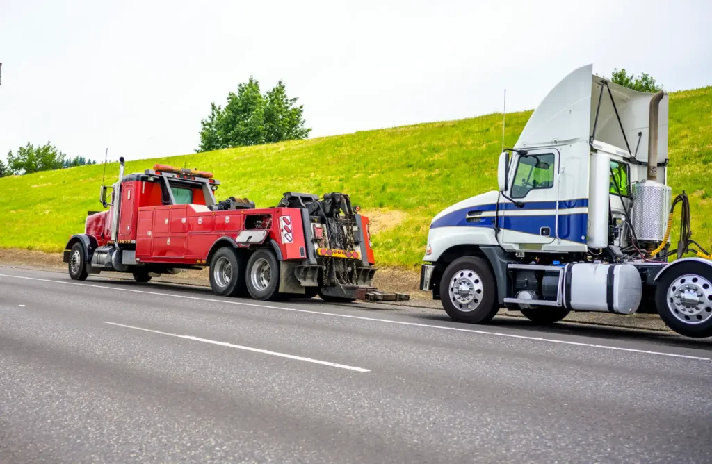 Two semi trucks parked on the roadside awaiting auto recovery services in Alsip,IL.