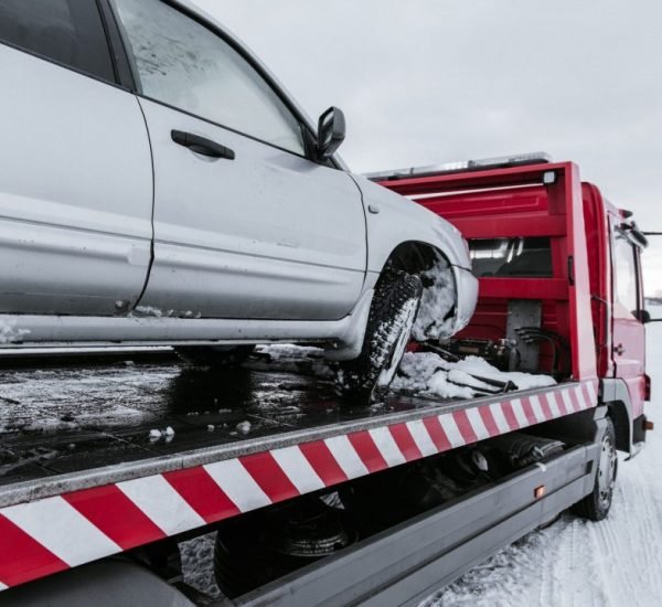 car-on-tow-truck-on-snow-road.jpg